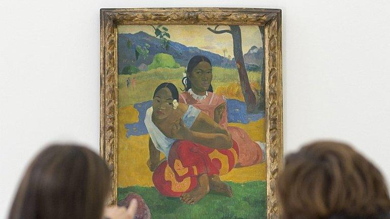 Two women look at the painting "Nafea faa ipoipo" (When will you marry?, 1892) by French painter Paul Gauguin on display in the Fondation Beyeler in Riehen, Switzerland, 06 February 2015