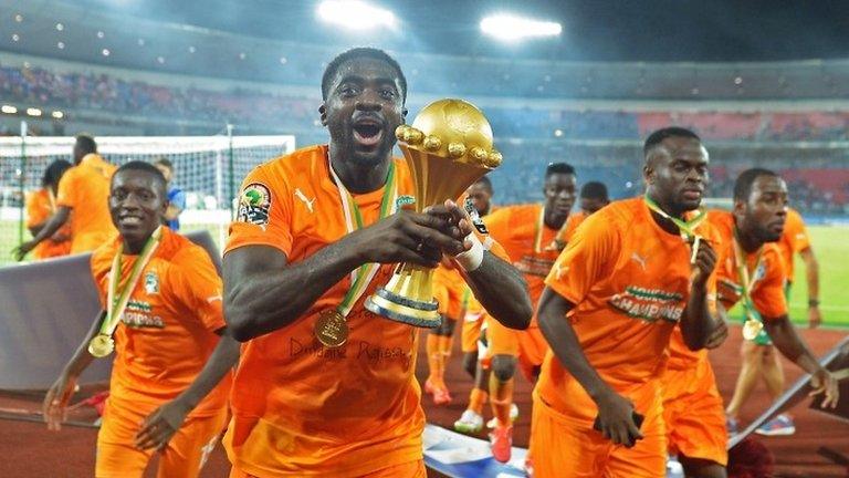 Ivory Coast's defender Kolo Toure raises the trophy as he celebrates after winning the 2015 African Cup of Nations