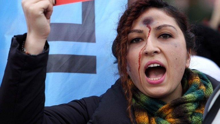 A woman with a bullet hole painted on her forehead takes part in a demonstration against the murder of 20-year-old Ozgecan Aslan, who was killed after she resisted an alleged attempt to rape her in the southern city of Mersin, in Ankara on Saturday