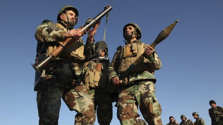 Kurdish Peshmerga fighters inspect an RPG launcher as they take control of the area, on the outskirts of Mosul in February 2015