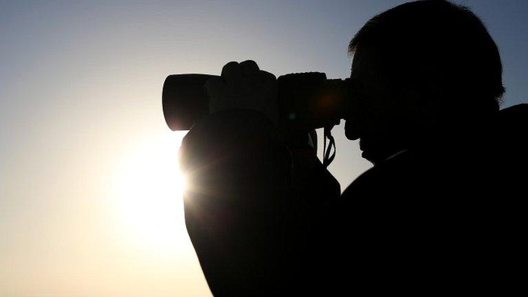 Man using binoculars (file photo)