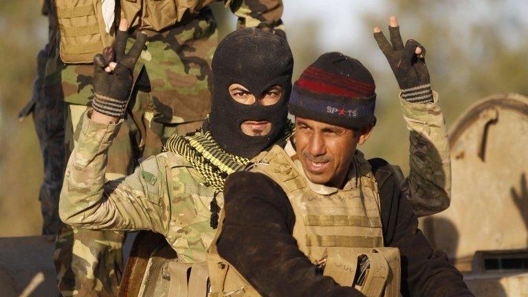 A Shia fighter gestures during clashes with Islamic State militants in Salahuddin province on 2 March 2015.