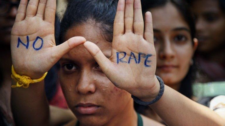 An Indian student displays "NO RAPE" message painted on her hands during a demonstration to demand death sentence for four men convicted of rape and murder of a student on a moving bus in New Delhi bus last year, in Hyderabad, India.