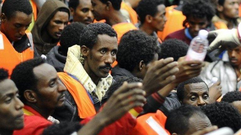 Migrants from Sub-Saharian areas receive bottles of water on a rescue boat of Italy"s Navy ship San Giorgio after being rescued in open international waters in the Mediterranean Sea between the Italian and the Libyan coasts May 14, 2014.