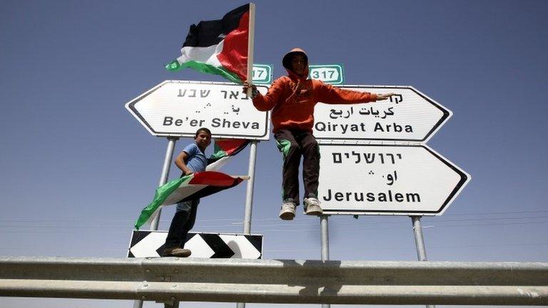 Palestinian protesters wave flags, 7 March