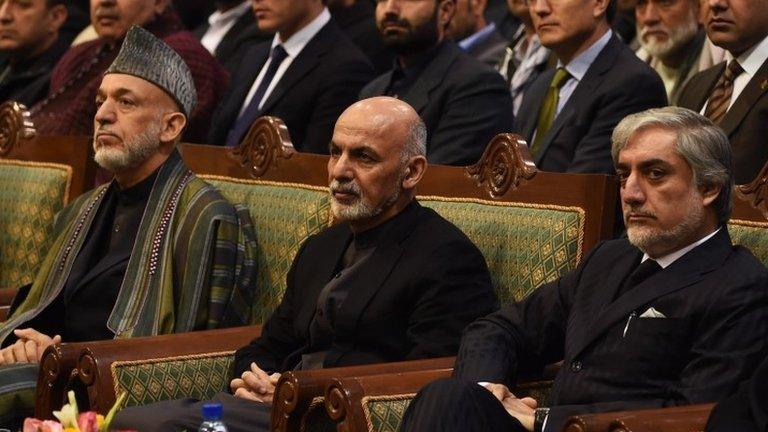 Afghan President Ashraf Ghani (C), Chief Executive Officer Abdullah Abdullah (R) and former president Hamid Karzai look on during a ceremony to mark the first anniversary of the death of former vice president Mohammad Qasim Fahim at the loya jirga hall in Kabul 9 March 2015