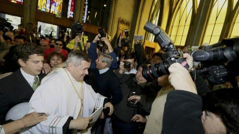 Protesters shout as Rev Juan Barros enter the Osorno cathedral