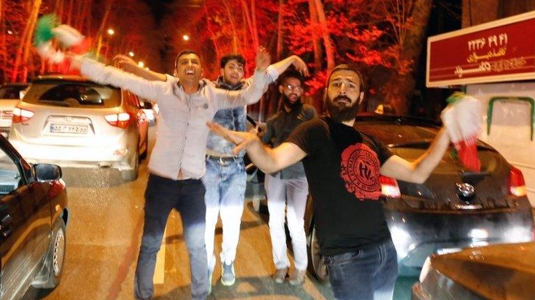 Iranians celebrate in the street of Tehran after the agreement was announced