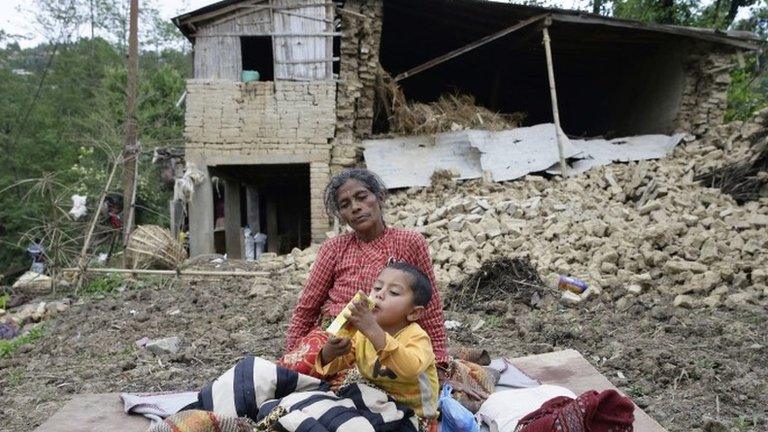 Earthquake victims in front of a destroyed house in Nepal, 27 April 2015