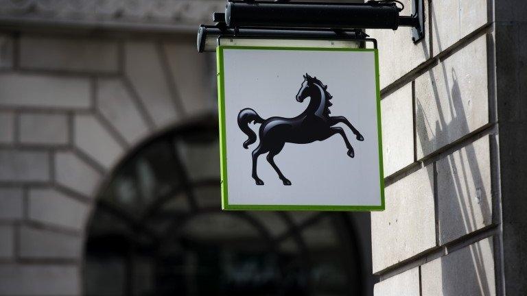 A Lloyds bank logo is displayed outside a branch on Piccadilly in London,