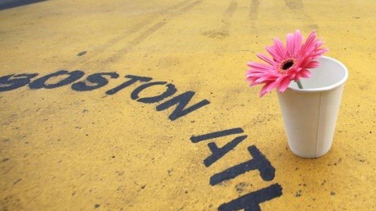 A flower in a cup on the finish line of the Boston Marathon