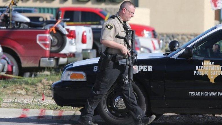 Authorities investigate a shooting in the parking lot of the Twin Peaks restaurant Sunday, May 17, 2015, in Waco, Texas.