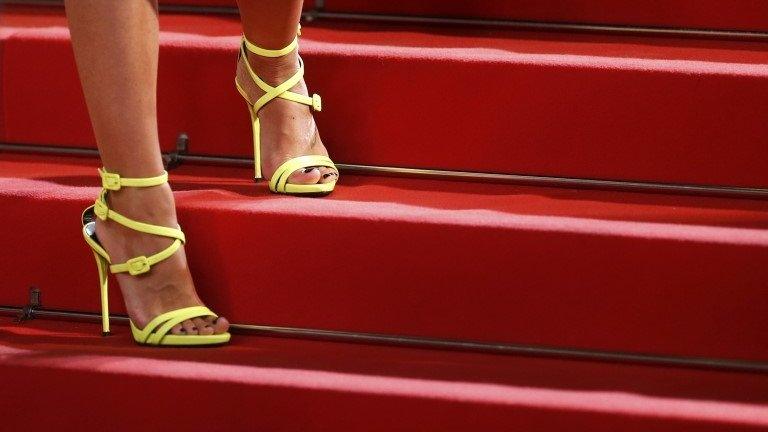 The shoes of an unidentified guest are pictured as she poses on the red carpet for the screening of The Lobster at the Cannes Film Festival