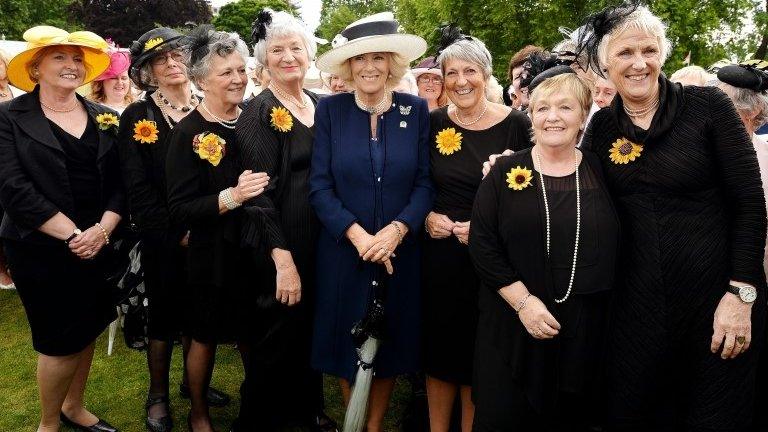 The Duchess of Cornwall poses for a photo with the WI's Calendar Girls