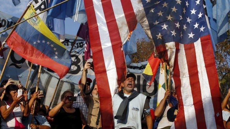 File photo: Supporters of Venezuela's President Nicolas Maduro shout slogans and wave a national flag of Venezuela (L) as they burn a US national flag during a demonstration outside the U.S. Embassy in Buenos Aires, 10 April 2015