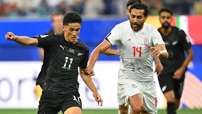 Elijah Just and Saman Ghoddos fight for the ball