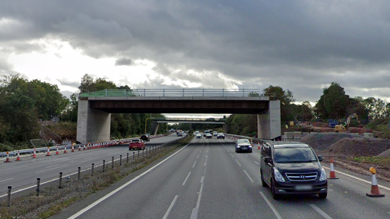 A bridge that runs over a motorway, but is not connected to at either side, meaning it is inaccessible to vehicles.