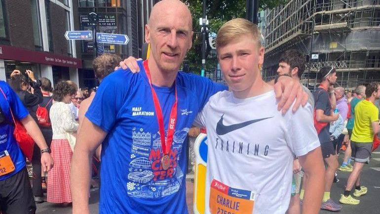Footballer Kevin Ellison pictured with his son, Charlie, after running the Manchester half marathon together in 2025