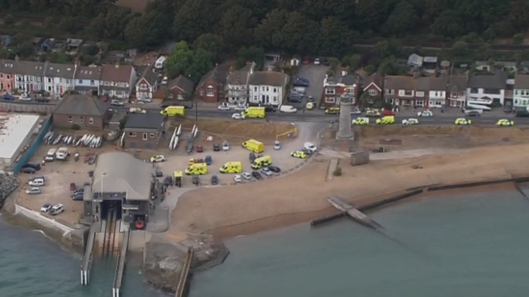 An aerial view shows ambulances, emergency vehicles and responders gathered on the seafront near Shoreham Port.