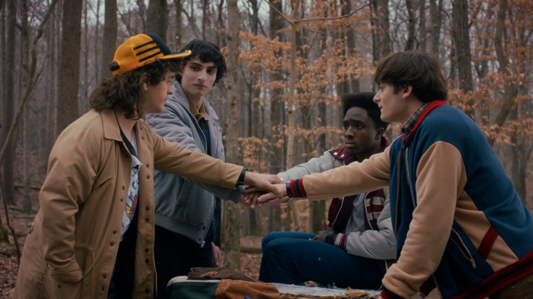 (L to R) Gaten Matarazzo as Dustin Henderson, Finn Wolfhard as Mike Wheeler, Caleb McLaughlin as Lucas Sinclair, and Noah Schnapp as Will Byers in Stranger Things: Season Five.