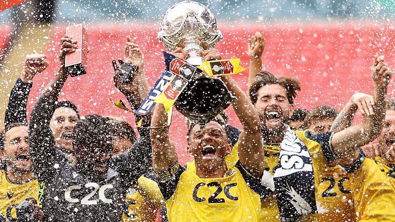 Southend United players, led by captain Nathan Ralph, celebrate lifting the FA Trophy at Wembley