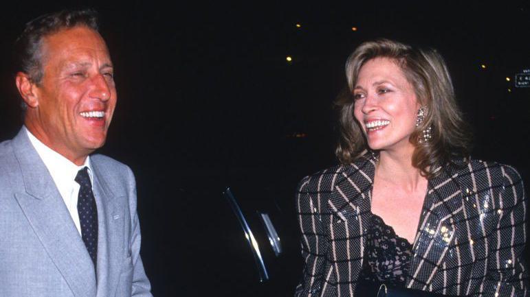 Frederick Forsyth and Faye Dunaway attend the premiere for The Fourth Protocol. They are laughing.