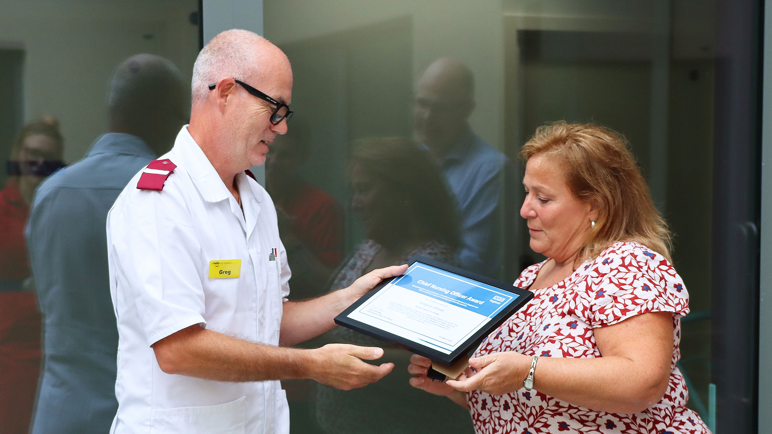 Gregory Jessop being handed his framed award