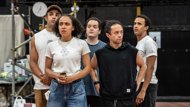 Five of the cast members in rehearsals.