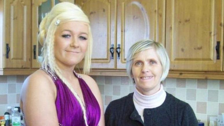 Shows Caoimhe O'Brien - with blond hair and a purple dress - and her mother Marie wearing a light-coloured polo neck under a dark button-up cardigan