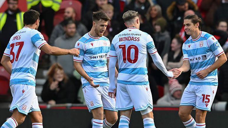 Josh Windass celebrates a Wrexham goal with team-mates