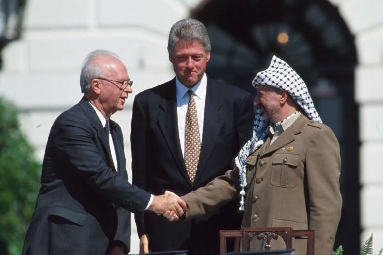 Yasir Arafat and Israeli Prime Minister Yitzhak Rabin shake hands on 13 September, 1993 in Washington DC