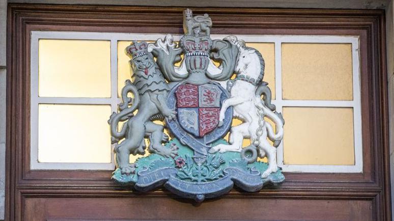 Crest above wooden door at the High Court in Belfast.
