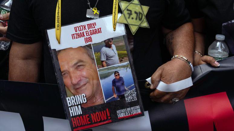 Daniel Elgarat, brother of hostage Itzik Elgarat, wears the Star of David as he takes part in the Israel Day on Fifth parade on 2 June 2024 in New York City.