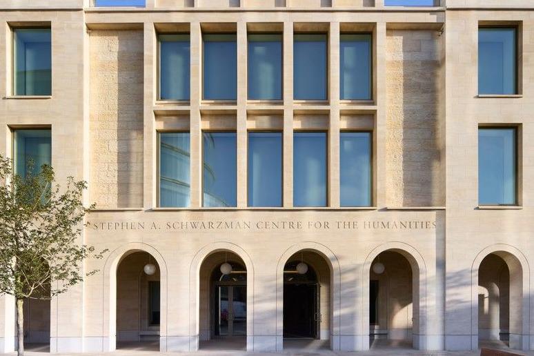 The front of the centre with large arches, tall windows, and made of the yellow/golden-ish Cotswold Stone typical of Oxford.
