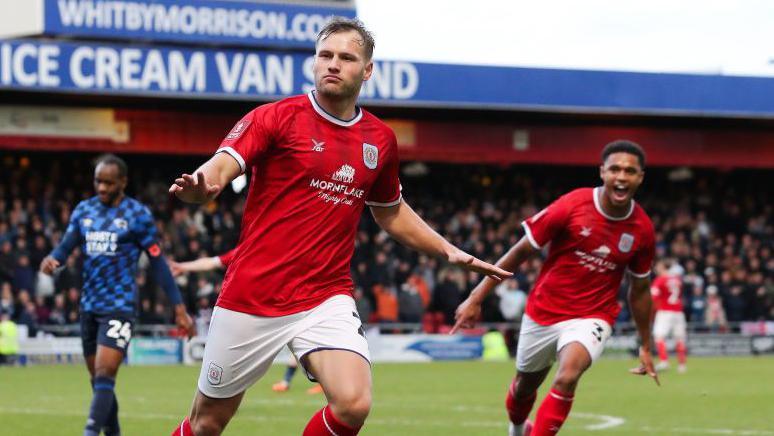 Elliott Nevitt celebrates scoring for Crewe