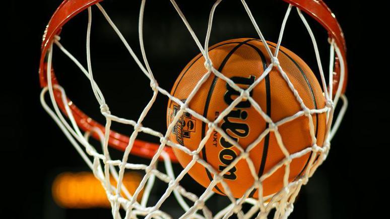 Generic shot of a basketball dropping through a hoop