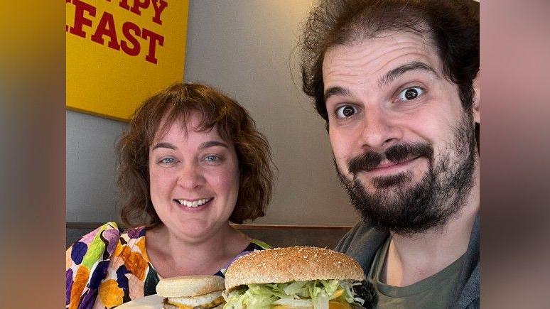 Claire and Antony Zupnik holding Wimpy meals