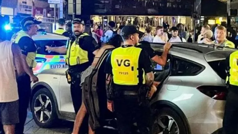 Police officers surround a car on Southend seafron