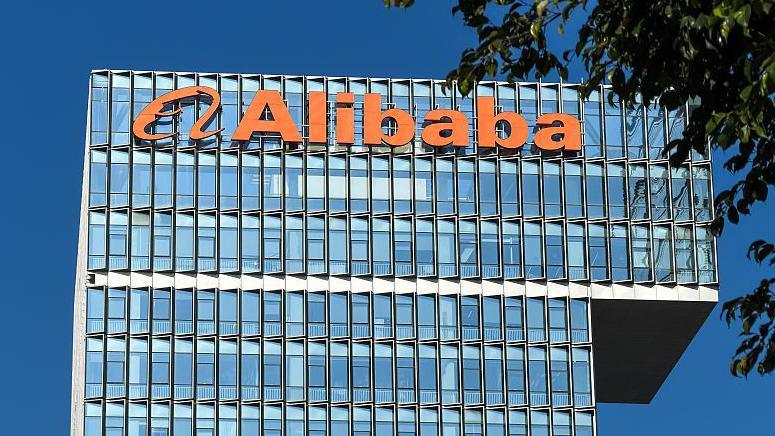 The Alibaba logo is displayed on a building at Shenzhen Alibaba Center