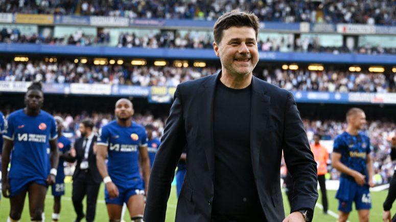 Mauricio Pochettino smiles on the pitch at Stamford Bridge 