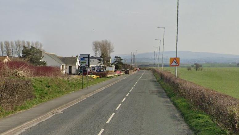 Oxcliffe Road surrounded by fields and residential buildings