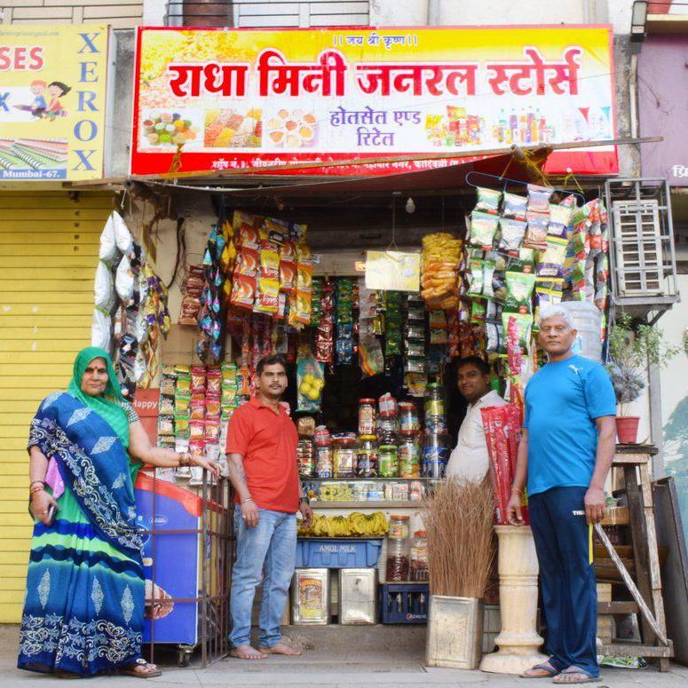 Radha Yadav’s family, including her father Omprakash (first from right), outside Radha Mini General Store in Kandivali, that she opened with her earnings