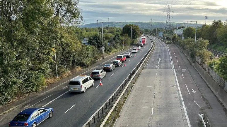 The Sydenham Bypass during its closure in October. There is one lane of traffic in the Bangor bound lane and a line of traffic cones blocking the outer lane. The Belfast bound lanes are empty.