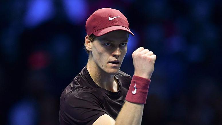 Jannik Sinner pumps his fist in celebration