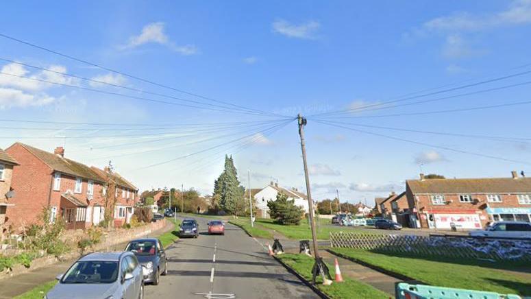 A general shot of Rectory Road in Sittingbourne with cars parked, houses and a grass verge