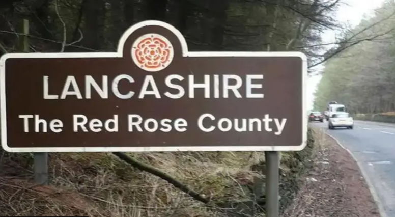 A sign marking the border with Lancashire "the Red Rose County"