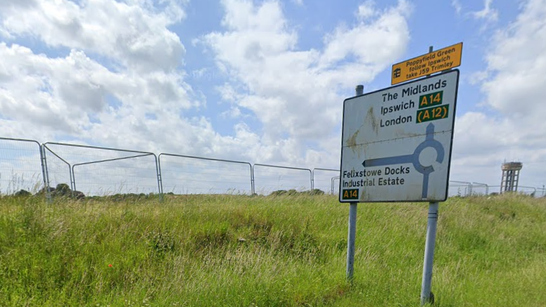 A road sign in Felixstowe coming out of a piece of land