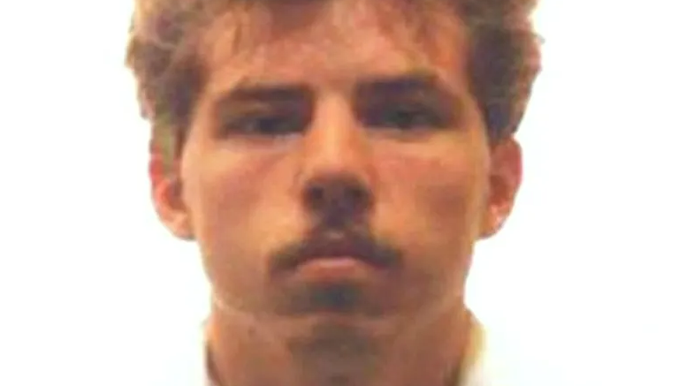 Mugshot of Dunlop. He has reddish hair and a moustache