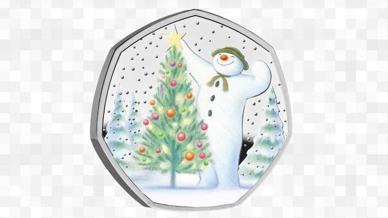 2024 Snowman 50p, showing The Snowman putting a gold star on a Christmas tree as snow falls