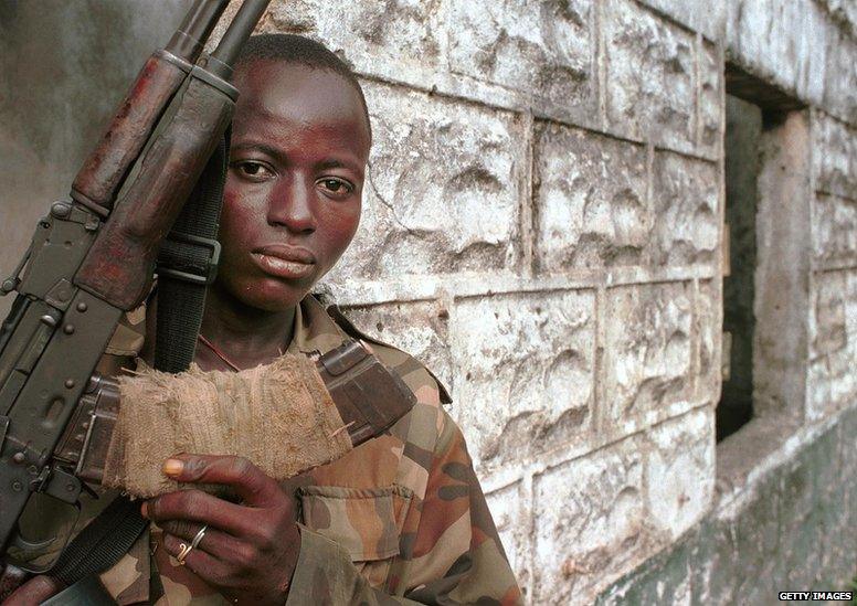 A teenage Revolutionary United Force rebel soldier. The RUF, infamous for their forced recruitment of child soldiers and maiming of civilians, slowly started to disarm and turn children soldiers over to international aid groups.